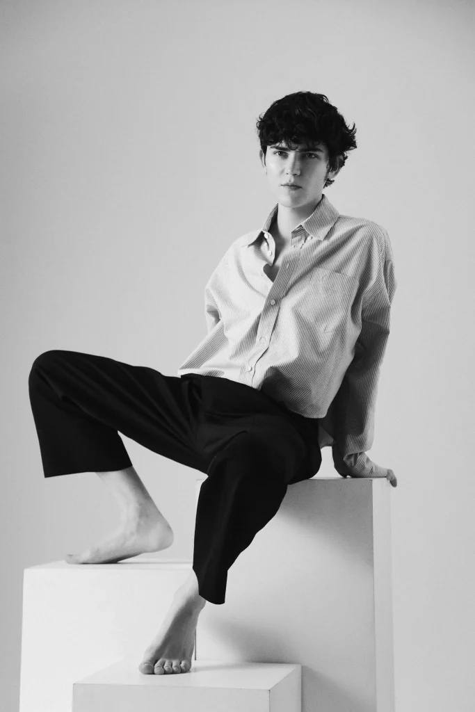 Gleb seated in a white shirt