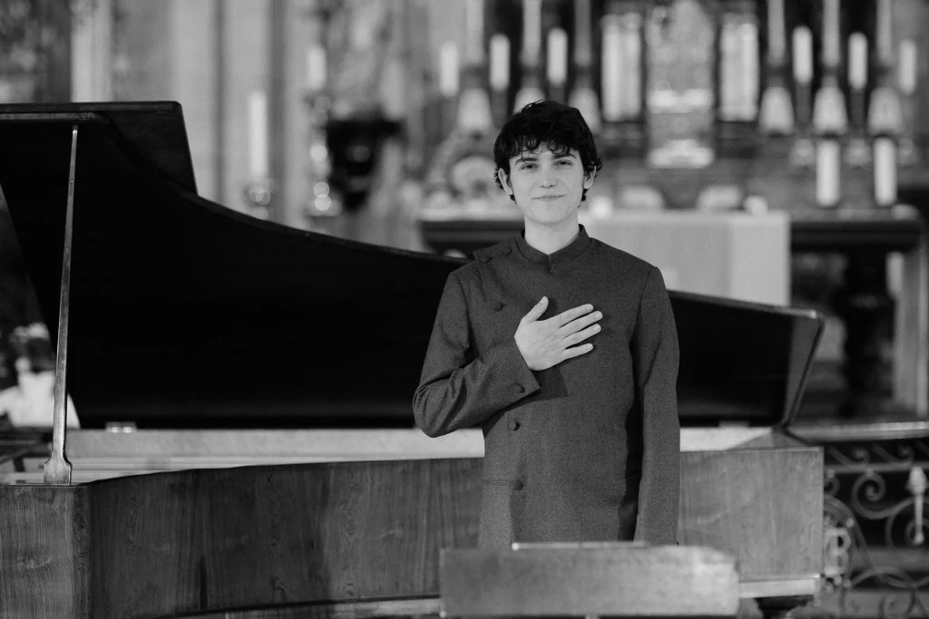 Gleb taking a bow with a hand on his chest